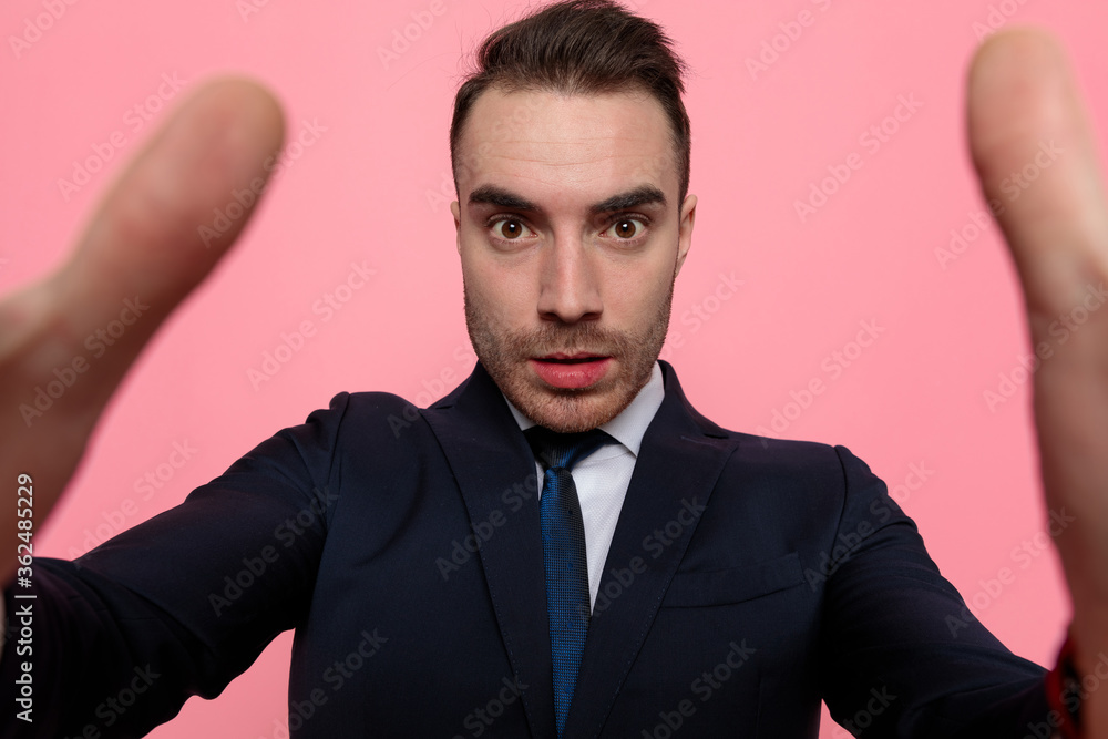 young elegant businessman in suit holding the camera young elegant businessman in suit holding the camera