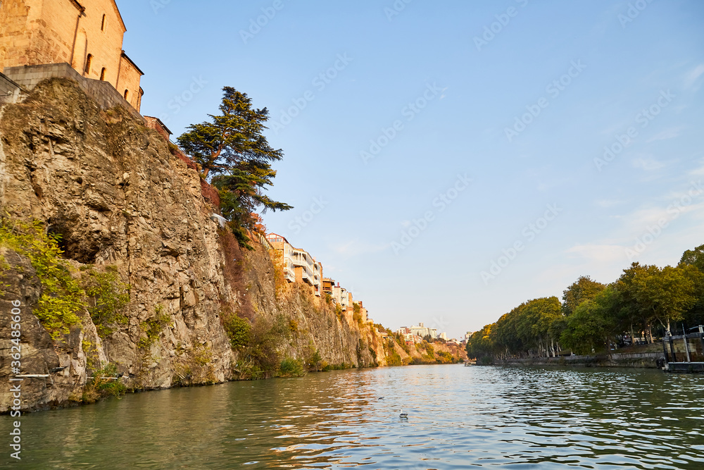 Tbilisi, Georgia - October 21, 2019: River Kura in capital of Georgia Tbilisi in a daytime and sightseeing from the water