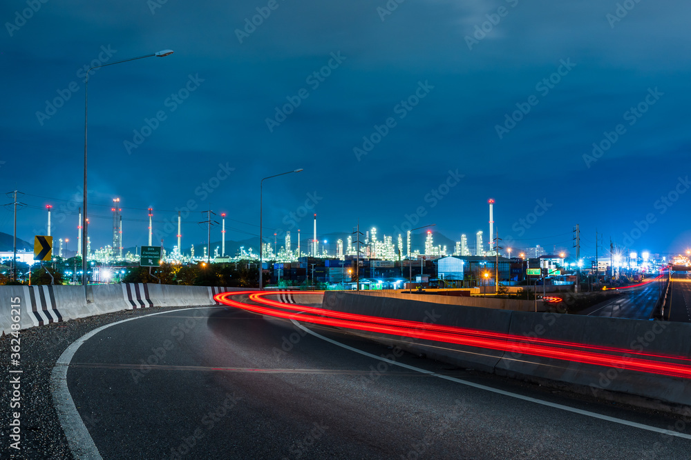 High angle with the light of the vehicle traveling at night, the background is Thai Oil Refinery Laem Chabang Industry Chonburi Province