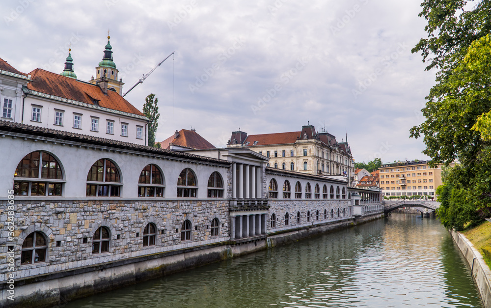The river Ljubljanica in Ljubljana, Slovenia with traditional architecture, churches and a stone bridge