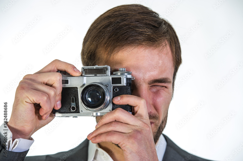 man photographs with an analog film camera, close-up. man photographs with an analog film camera, close-up.