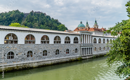 The river Ljubljanica in Ljubljana, Slovenia with traditional Slovenian architecture and Ljubljana Castle on the hill