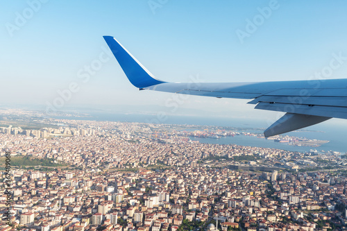 A panoramic top view from a n airplan of the beautiful city Istanbul and the Bosphorus under the blue sky. Banner, wallpaper concept.