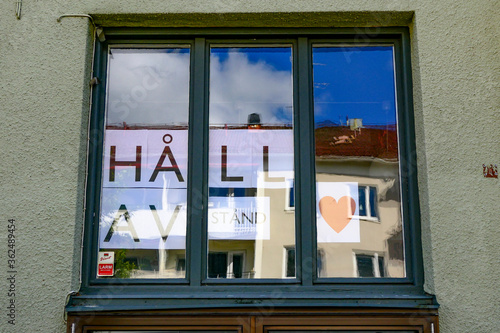 Lidkoping, Sweden A sign in the window of the community center says in Swedish to social distance, or hall avstand.