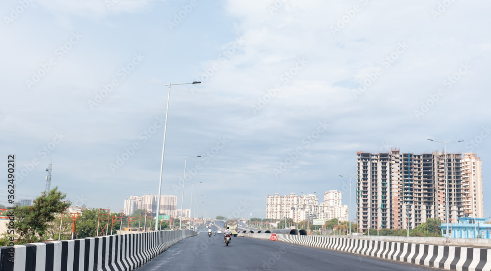 Indian Road Highways, Newly developed Delhi-Meerut Expressway landscape view in Early morning with clouds in blue sky, Ghaziabad, India, July 2020