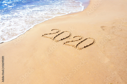 Number 2020 year on the sand sea shore