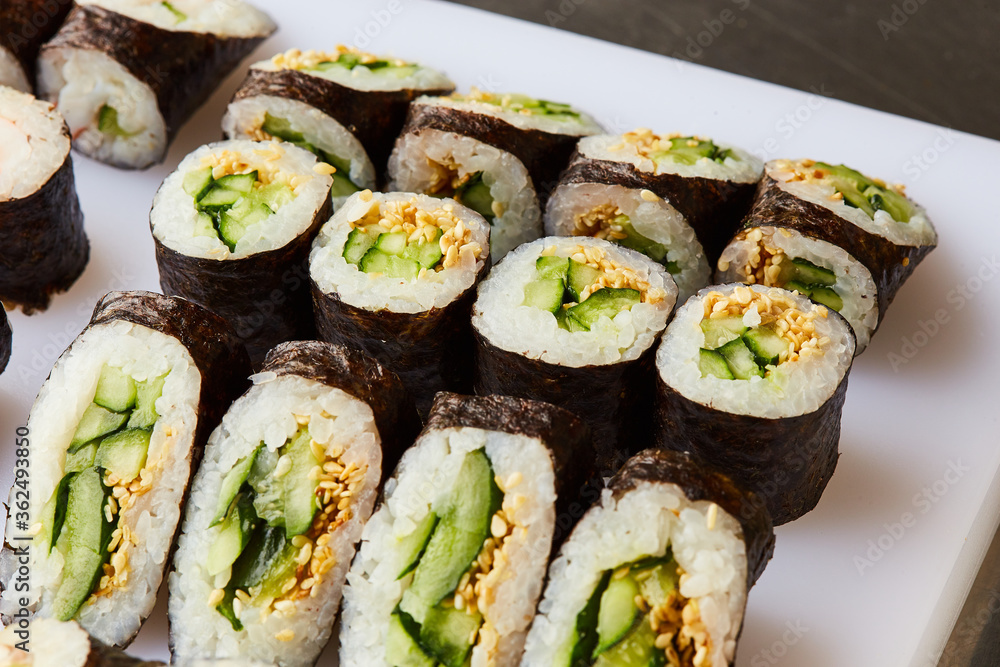 Various kinds of sushi roll set served on cutting board. Japanese food Various kinds of sushi roll set served on cutting board. Japanese food