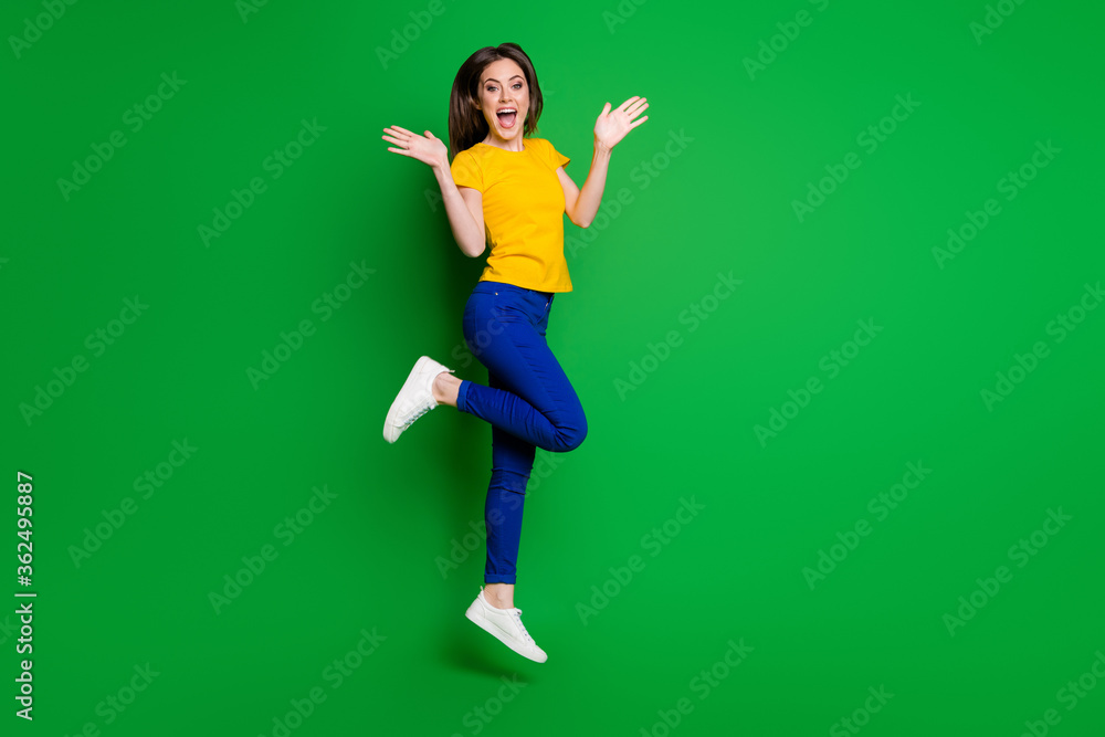 Full length body size view of her she nice attractive pretty girlish funky amazed cheerful cheery slim fit girl jumping having fun win winner isolated bright vivid shine vibrant green color background