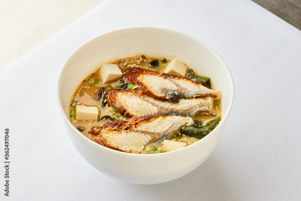 Japanese miso soup with eel in white bowl - Traditional asian dish