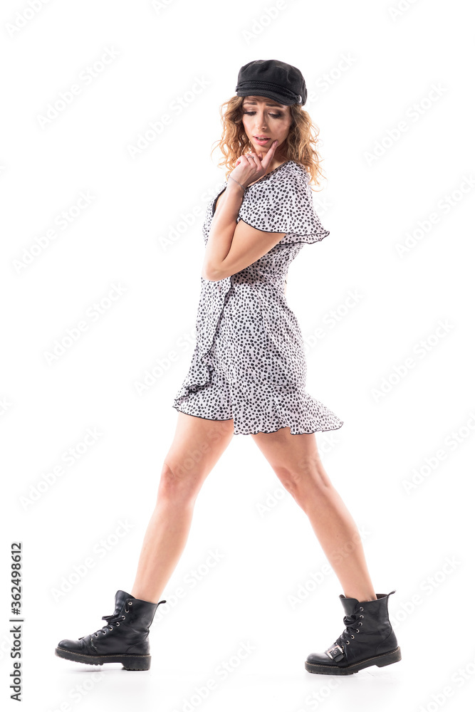 Side view of young beautiful stylish woman walking and looking down finding something on the ground. Full length isolated on white background. Side view of young beautiful stylish woman walking and looking down finding something on the ground. Full length isolated on white background.