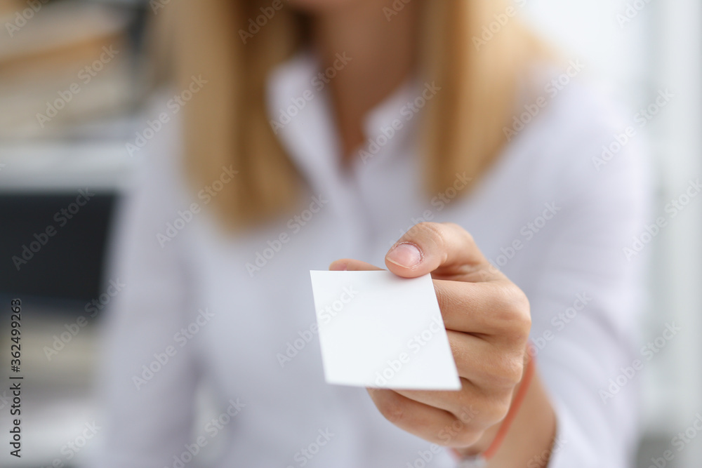 Female hand in suit give blank calling card to male visitor closeup. White collar partners company name exchange, executive or ceo introducing at conference, product consultant, sale clerk concept Female hand in suit give blank calling card to male visitor closeup. White collar partners company name exchange, executive or ceo introducing at conference, product consultant, sale clerk concept