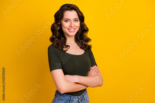 Portrait of her she nice-looking attractive lovely cute winsome cheerful cheery wavy-haired girl folded arms isolated on bright vivid shine vibrant yellow color background