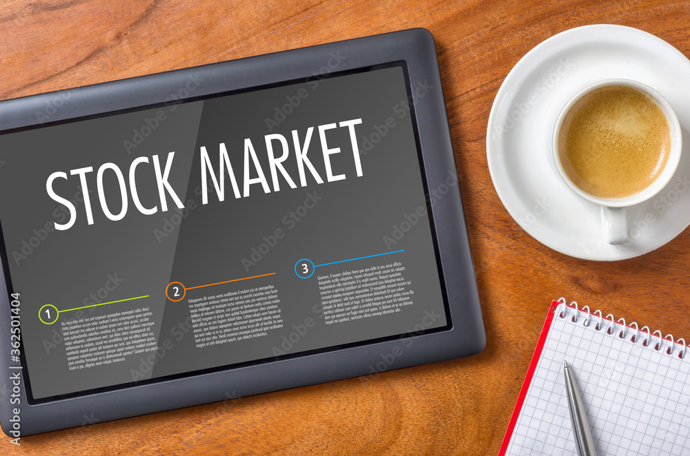 Tablet on a wooden desk - Stock Market Tablet on a wooden desk - Stock Market