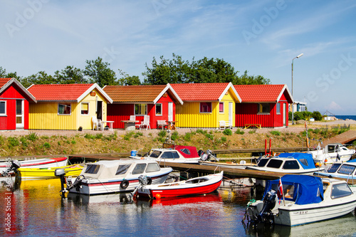 NEXO, DENMARK - JUNE 21: Red and yellow coastal wooden houses in Nexo on Bornholm island, Denmark on June 21, 2014. photo