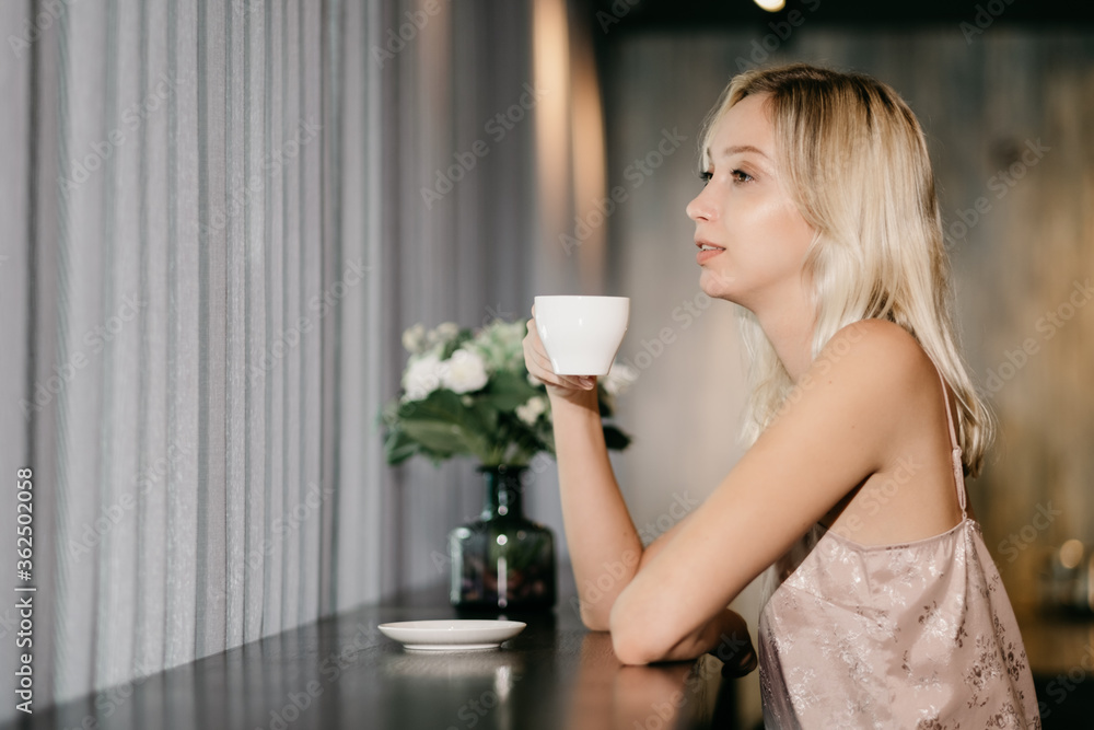 Beauty russia woman drink coffee and enjoy a wonderful morning in the hotel By the window Beauty russia woman drink coffee and enjoy a wonderful morning in the hotel By the window