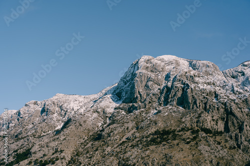 Snow-capped mountain peaks in Boka Kotorska. Winter in Montenegro in Kotor Bay.