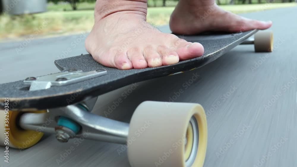 skateboading close up on bare foot in asphalt skateboading close up on bare foot in asphalt