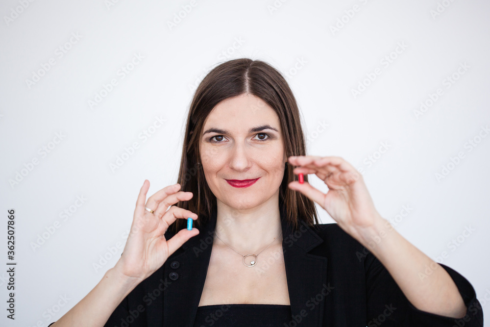 The girl holds two tablets blue and red, choice, matrix, new knowledge, treatment for the disease, antibiotics, The girl holds two tablets blue and red, choice, matrix, new knowledge, treatment for the disease, antibiotics,