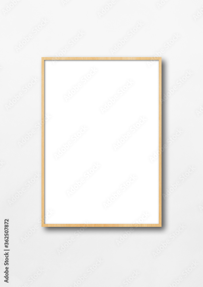 Wooden picture frame hanging on a white wall Wooden picture frame hanging on a white wall