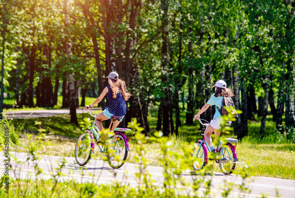 Fototapeta premium Cyclists ride on the bike path in the city Park 