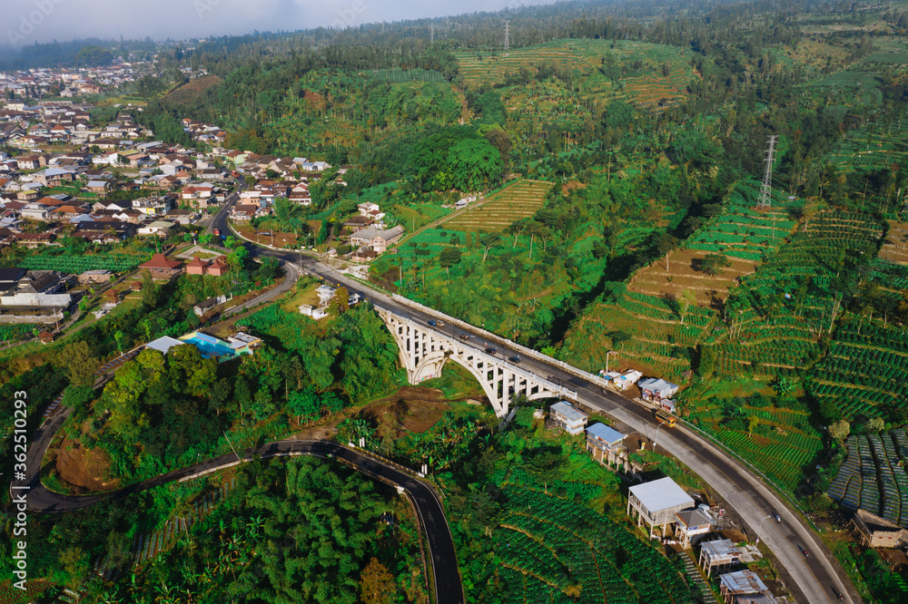 Morning view of Sigandul Bridge with Sindoro mountain baground.