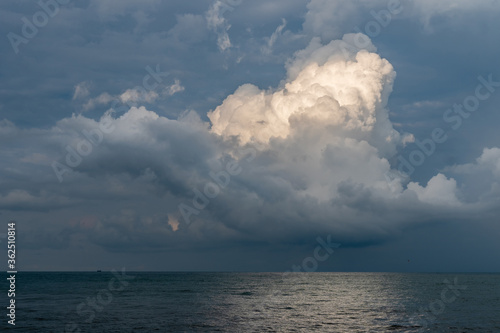 Calm Sea, Black Sea and white clouds on a Blue Sky Background