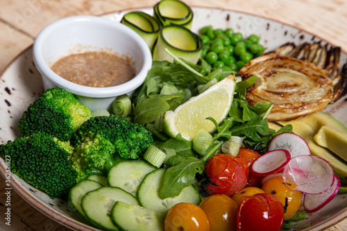 Close up of pea salad avocado broccoli cucumber radish and onion. Healthy cooking concept. Vegan cuisine