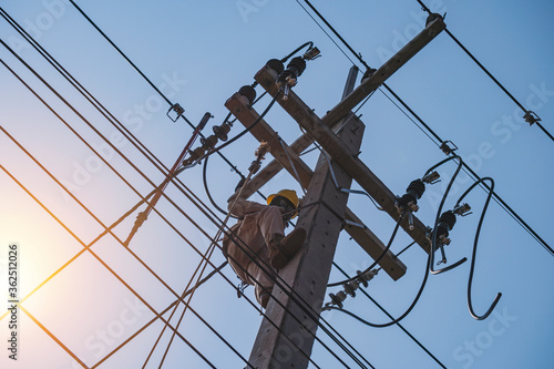 The power lineman uses insutated tool to open the connection of the transformer from the high voltage distribution system. To change the drop out fuse cut out that protects the transformer.