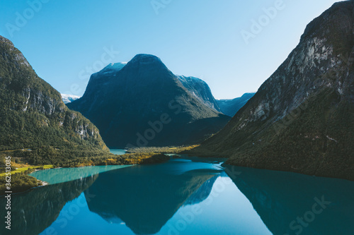 Norway landscape Lovatnet lake and mountains water reflection morning scenery travel scandinavian beautiful destinations. photo