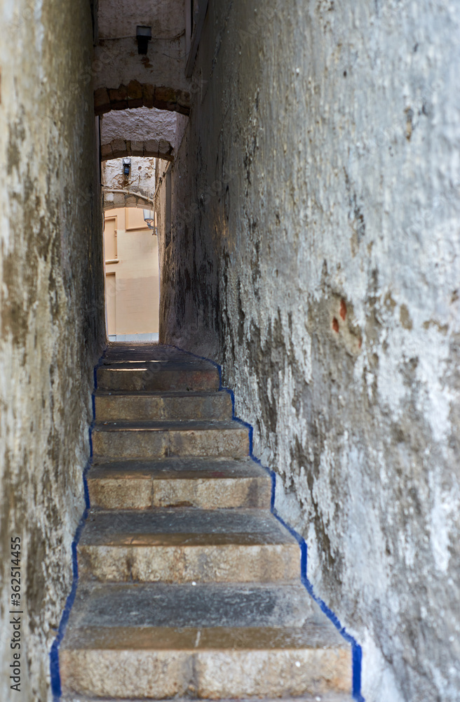 Old stairs going up an alley