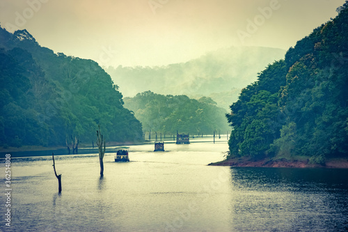 A scenic view of tourists boats on lake at Periyar national park photo