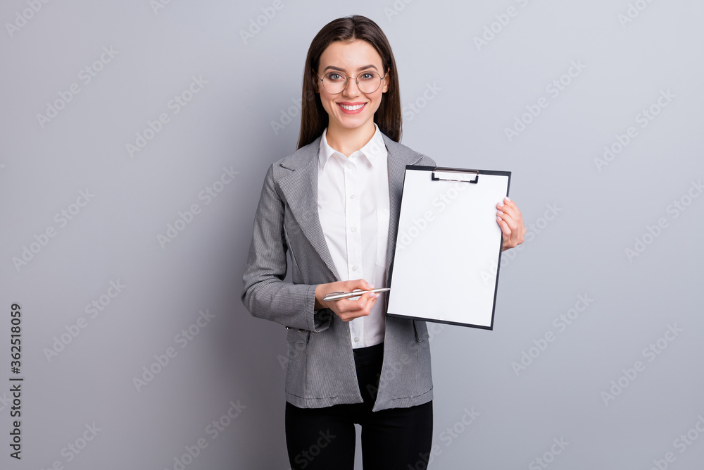 Photo of attractive business lady manager worker hold clipboard showing client place for signing contract real estate agent wear specs shirt plaid blazer isolated grey color background Photo of attractive business lady manager worker hold clipboard showing client place for signing contract real estate agent wear specs shirt plaid blazer isolated grey color background