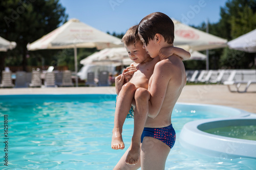 Two brothers near the pool on a summer day