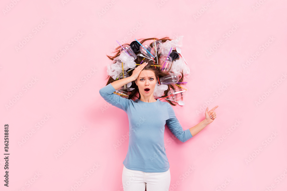 Fototapeta premium Top view above high angle flat lay flatlay lie concept of worried scared girl with junk in hair demonstrating help save planet earth ecosystem solution decision isolated pink pastel color background