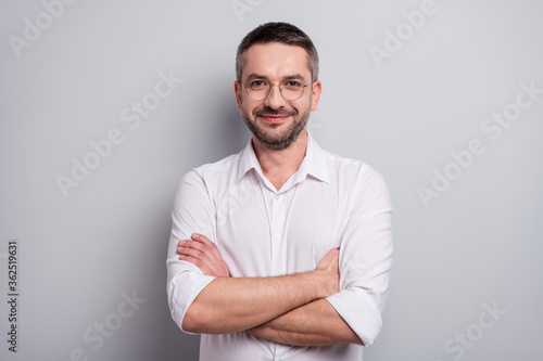 Close-up portrait of his he nice attractive cheery content mature man skilled qualified banker financier specialist wearing specs folded arms isolated over light gray pastel color background