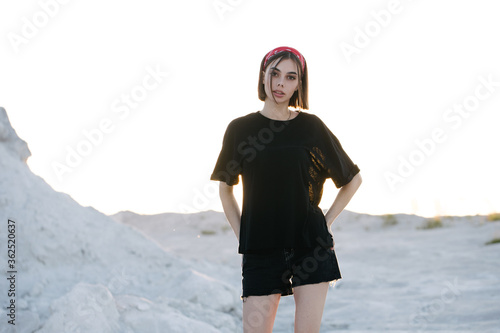 Sexy woman or girl wearing black blank t-shirt with space for your logo, mock up or design outdoors
