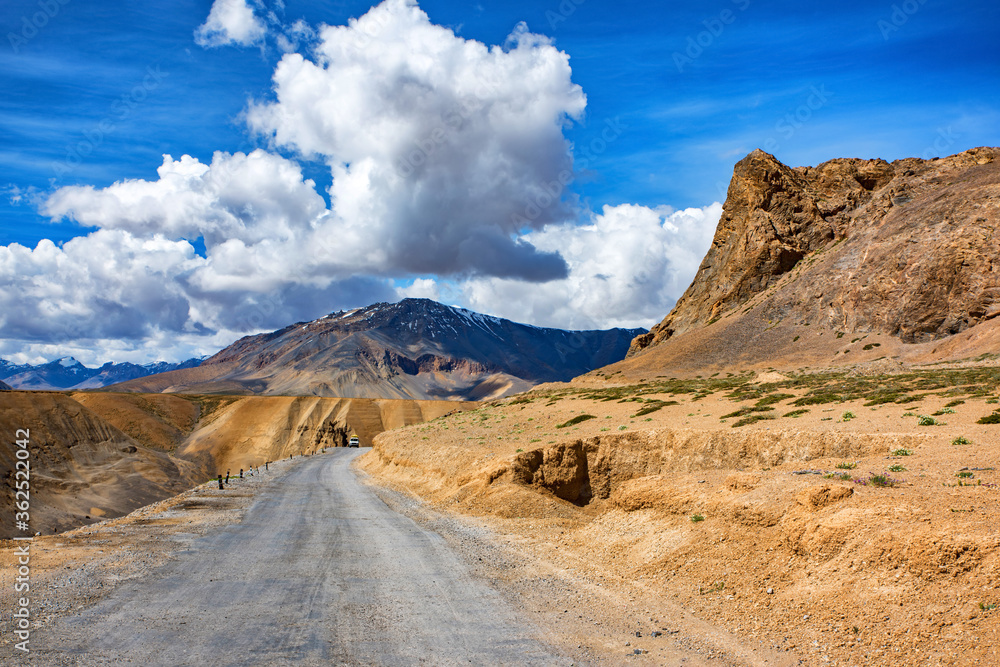 View of arid landscape of highway road for travel with big mountain and blue sky as background, Leh Ladakh - India