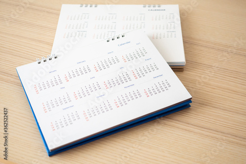 Calendar page close up on wood table background business planning appointment meeting concept