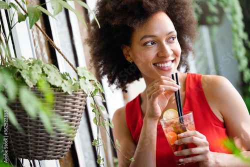 Young african woman enjoy healthy vegetarian smoothie for weight loss