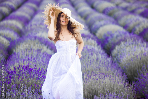 Young beautiful woman in lavender field. Lady on summer background