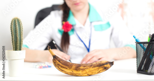 Black banana in the foreground in the office of a doctor of a sex therapist.  photo