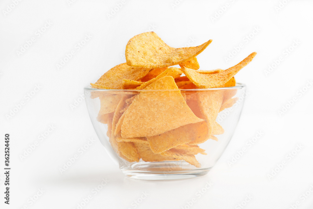 Traditional snack at bar. Glass bowl with nachos isolated on white background Traditional snack at bar. Glass bowl with nachos isolated on white background