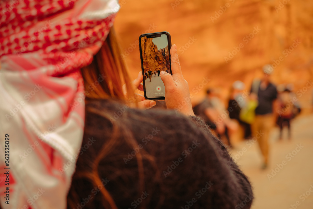 woman taking a photo in the ancient city of petra