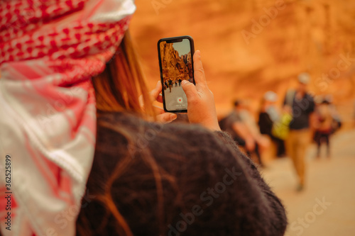 woman taking a photo in the ancient city of petra