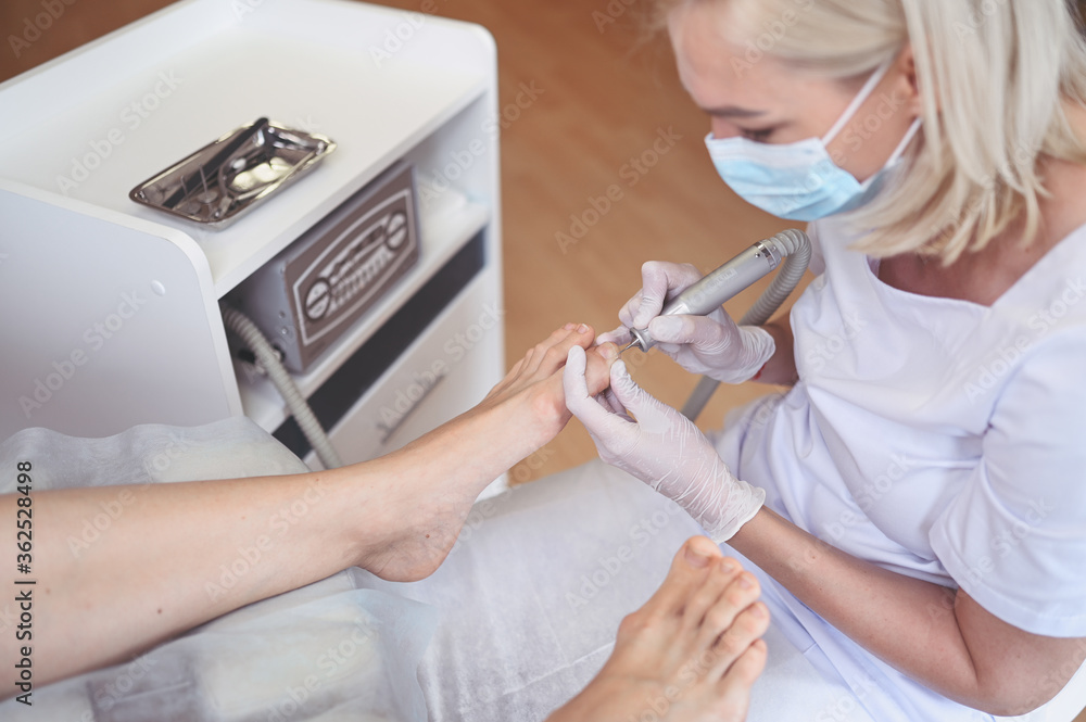 Hardware medical pedicure with nail file drill apparatus. Patient on