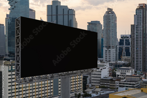 Photography Blank black road billboard with Bangkok cityscape background at sunset