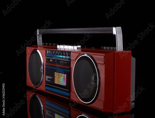 Vintage red boom box on black background with reflection