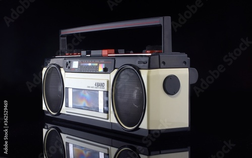 Vintage boom box on black background with reflection