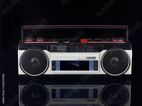 Vintage boom box on black background with reflection