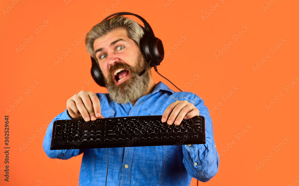 Superior performance. Graphics settings pushed to limit. Play computer games. Man bearded hipster gamer headphones and keyboard. Gaming addiction. Online gaming. Modern leisure. Run any modern game Superior performance. Graphics settings pushed to limit. Play computer games. Man bearded hipster gamer headphones and keyboard. Gaming addiction. Online gaming. Modern leisure. Run any modern game